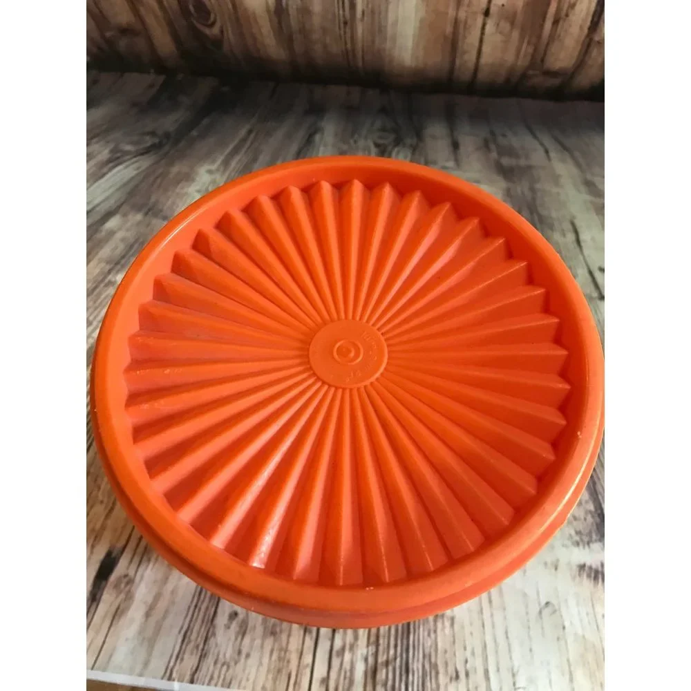 Vintage 70’s tangerine orange Tupperware canister with lid.